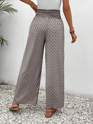 Palazzo pants with a smocked waist and allover geometric print in beige and black.