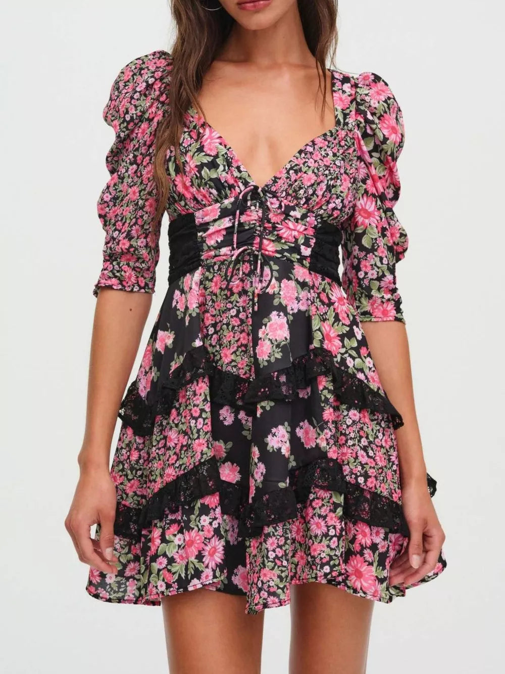 Ruched floral tie-front dress with black lace trim and puff sleeves.