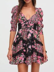 Ruched floral tie-front dress with black lace trim and puff sleeves.