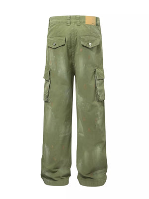 Green distressed cargo pants with multiple pockets and paint-splatter accents.