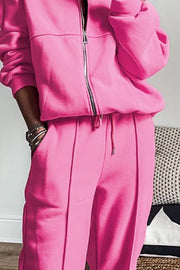 Fuchsia pink seamed jogger set with zip-up jacket and drawstring waist.