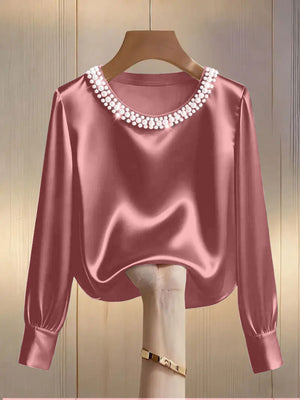 Pink satin blouse with pearl trim round neckline and long sleeves