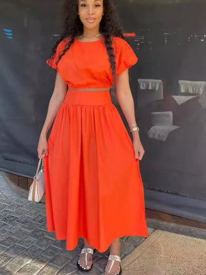 Orange crop top and maxi skirt set with short sleeves and a high waist.