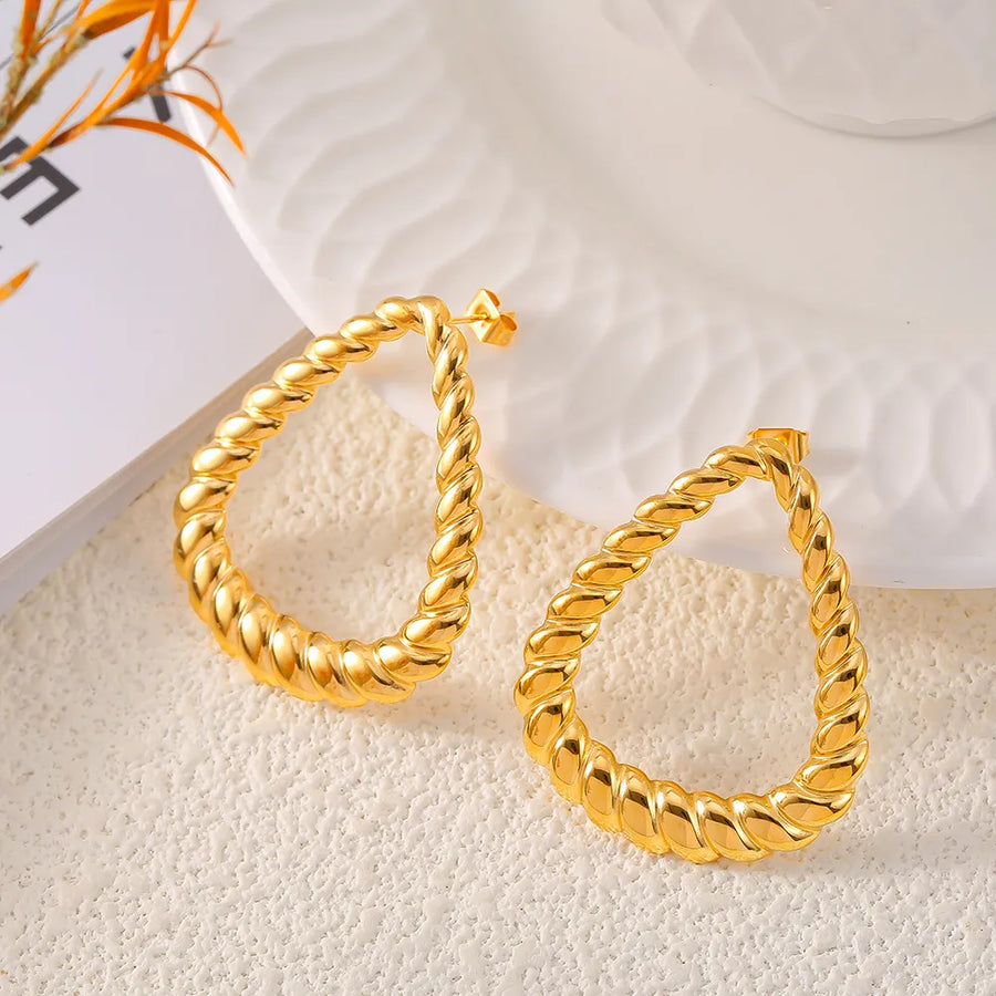 Gold teardrop hoop earrings with rope texture detail