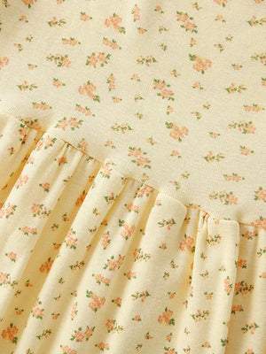 Delicate floral toddler dress in pale yellow with short sleeves and a ruffled hem.