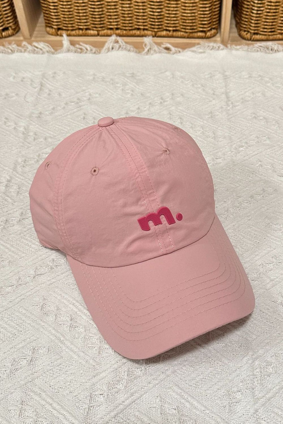 Pink baseball cap with embroidered pink 'm' logo