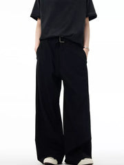 Men's black wide-leg sweatpants with a silver buckle detail and pockets.