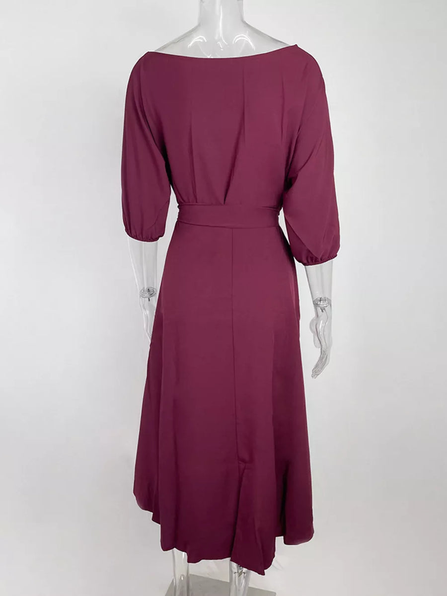 Burgundy off-the-shoulder belted dress with 3/4 sleeves and a flowing skirt.