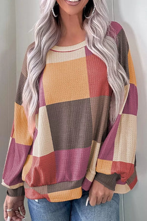 Multicolor patchwork waffle knit top with round neck and long sleeves.