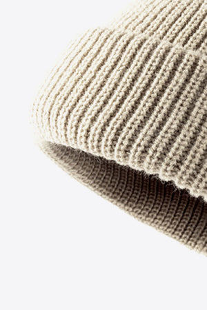 Beige ribbed knit beanie with folded edge detail