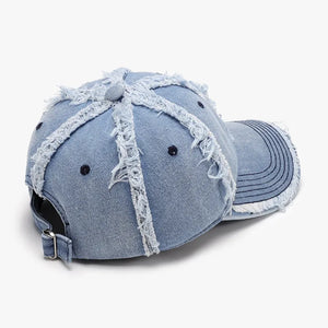 Light wash denim baseball cap with distressed frayed details and adjustable strap.