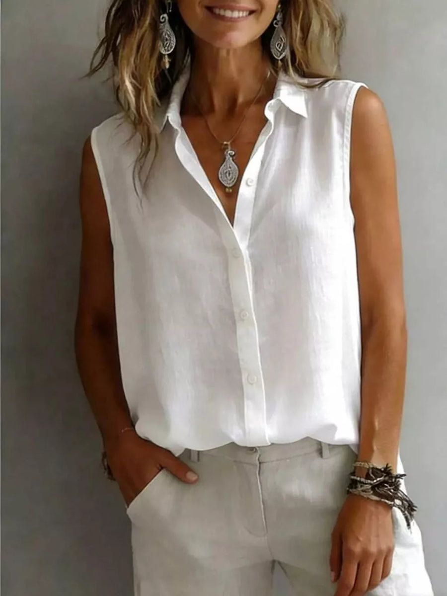 White sleeveless button-up shirt with a classic collar and button front.