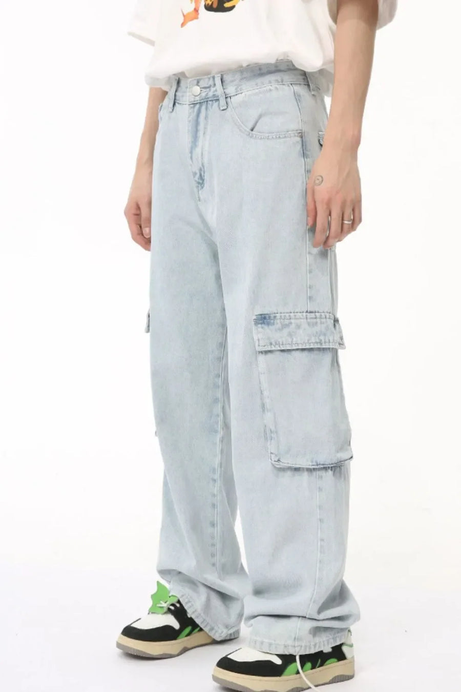 Baggy light wash denim cargo pants with large side pockets and a relaxed fit.
