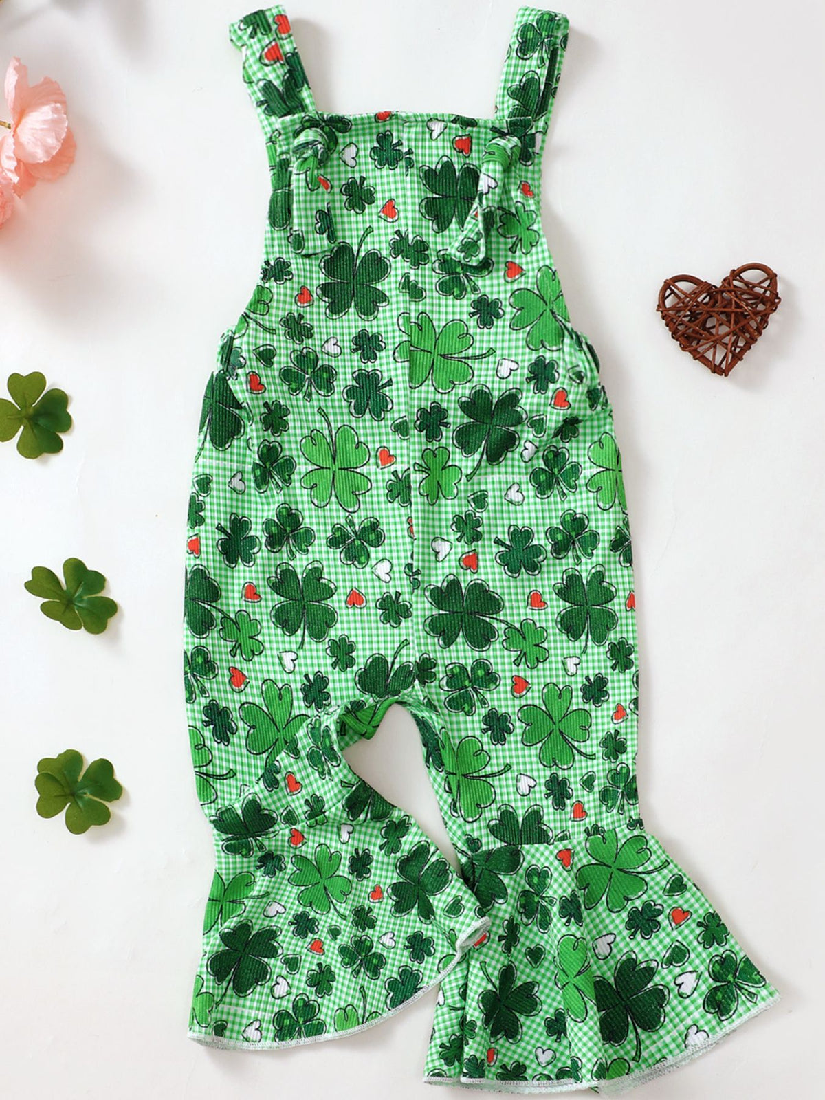 Green baby overalls with clover and heart pattern, featuring flare legs and adjustable straps.