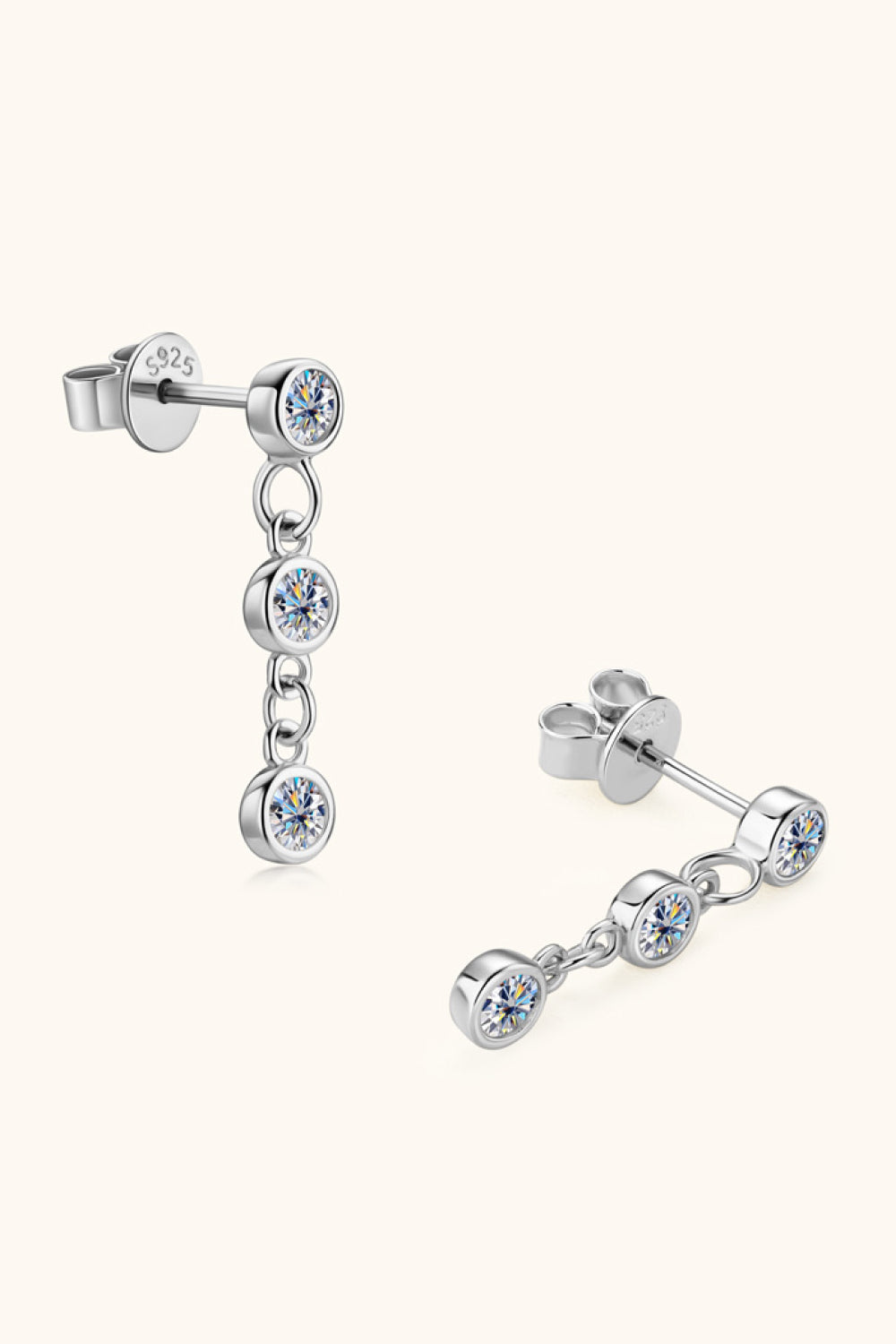 Silver triple stone cascade drop earrings with clear cubic zirconia gems.