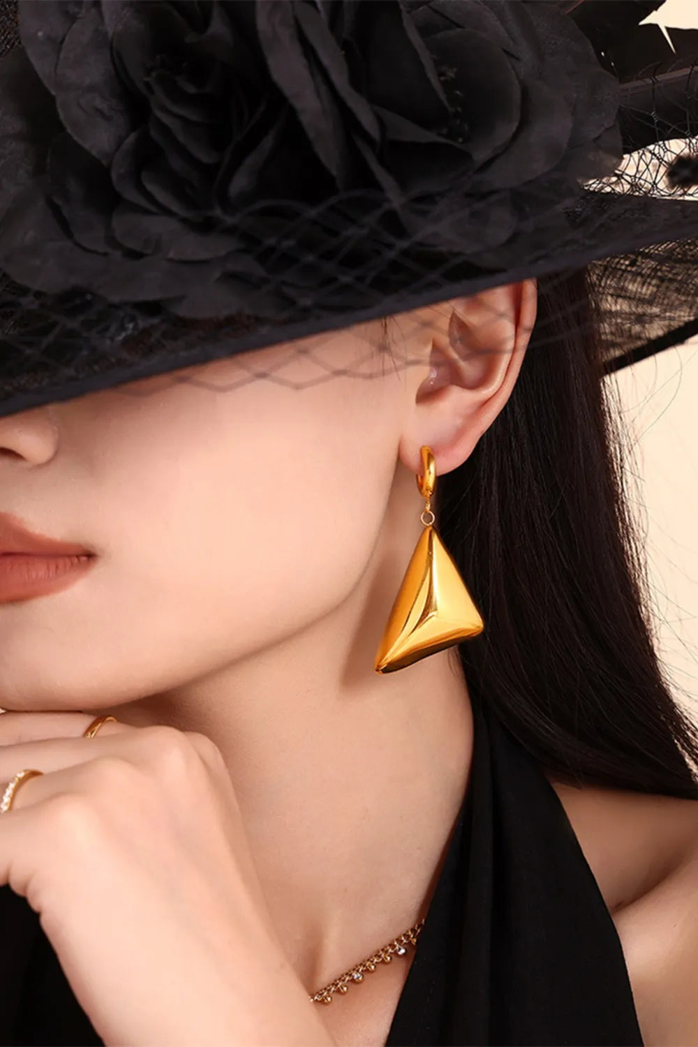 Gold pyramid drop earrings with a polished finish.