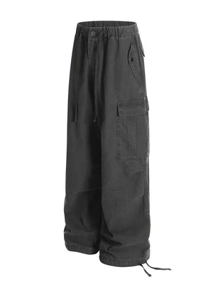 Grey cargo pants with adjustable drawstring waist and hem, featuring multiple pockets.