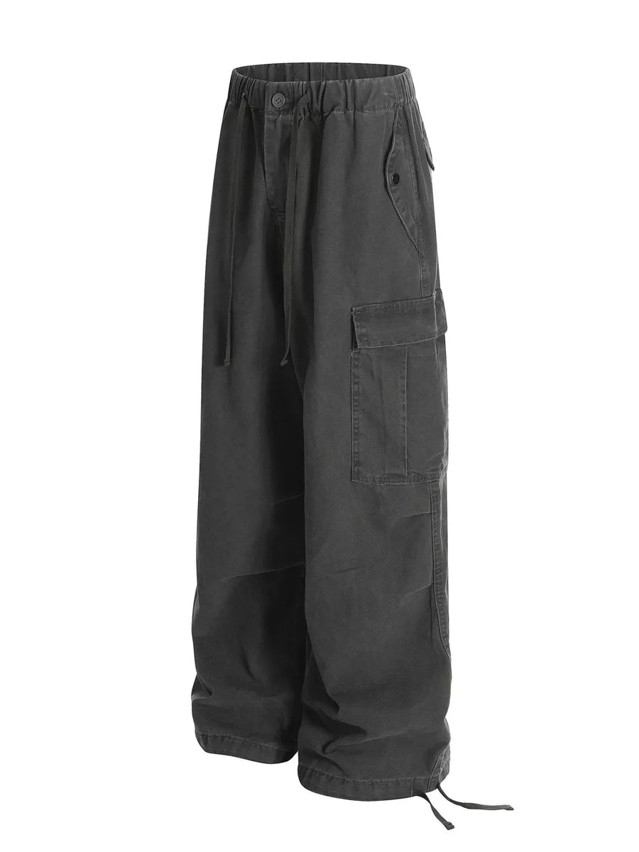 Grey cargo pants with adjustable drawstring waist and hem, featuring multiple pockets.