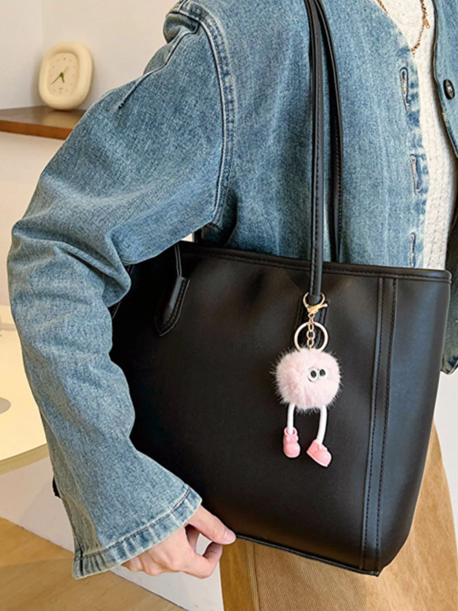 Black PU leather tote bag with a fluffy pink character keychain.