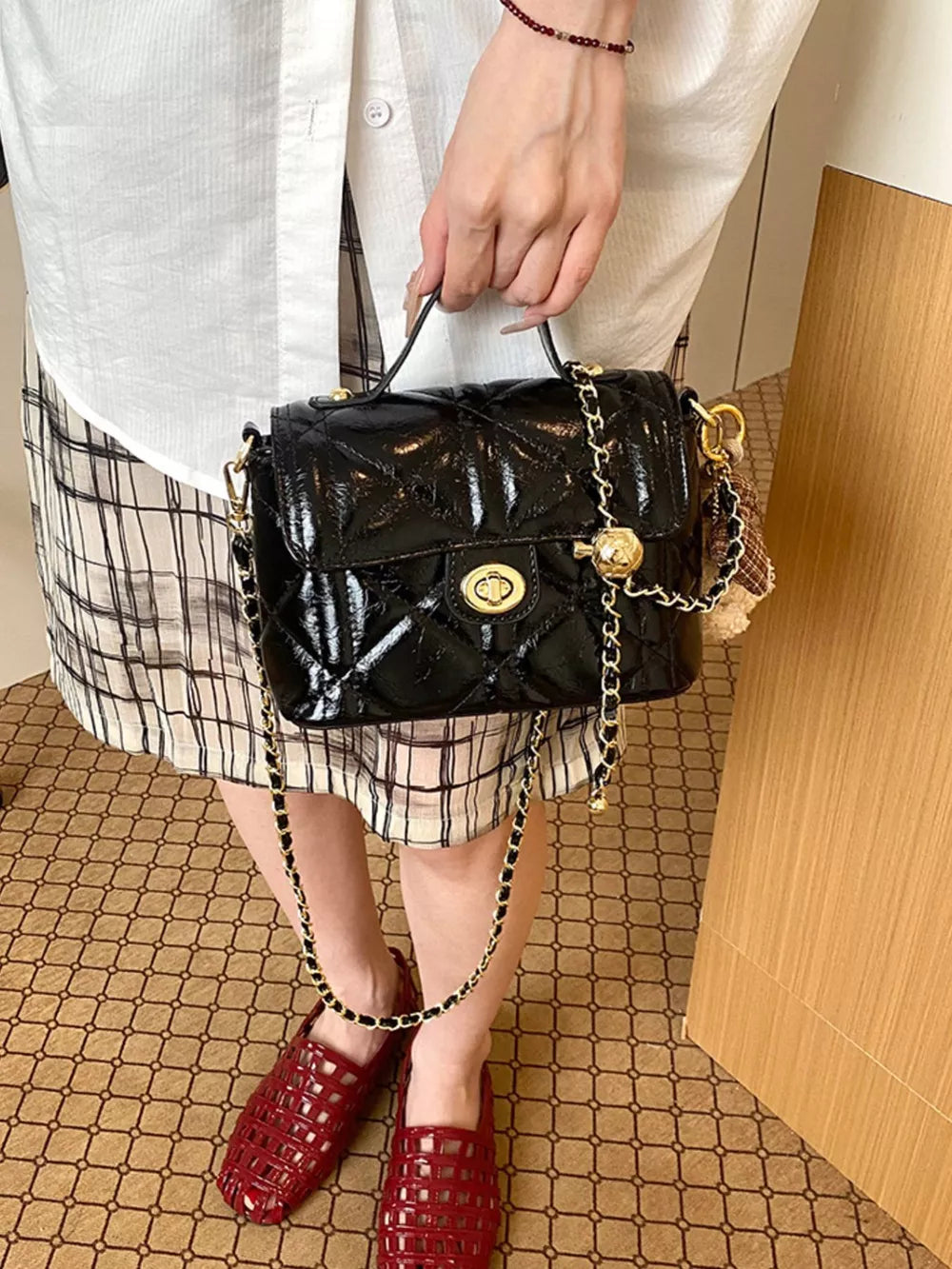 Black crossbody bag featuring quilted and quilted