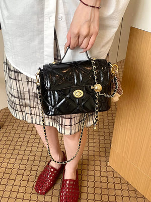 Black crossbody bag featuring quilted and quilted