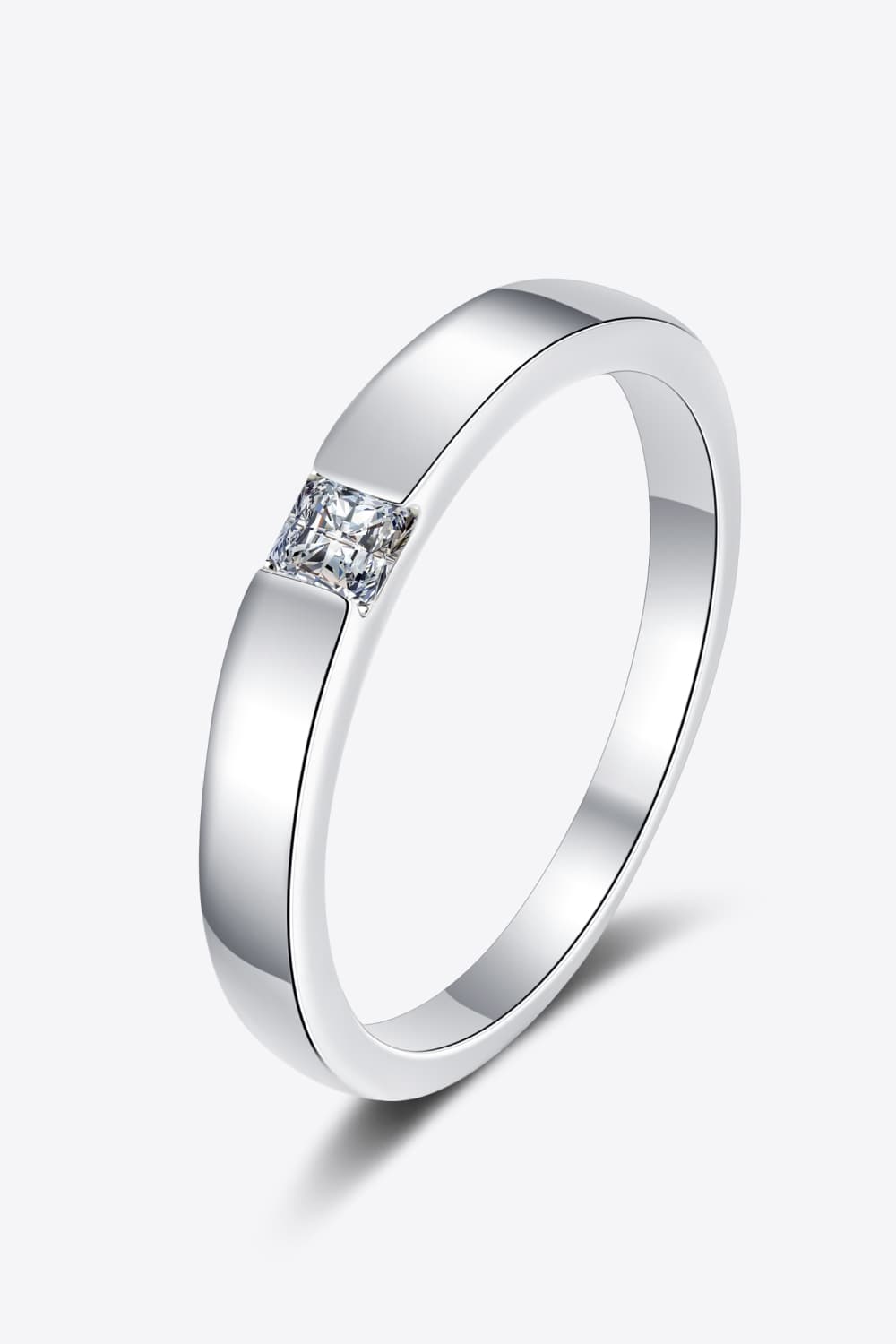 Silver band ring with a single princess-cut solitaire diamond.