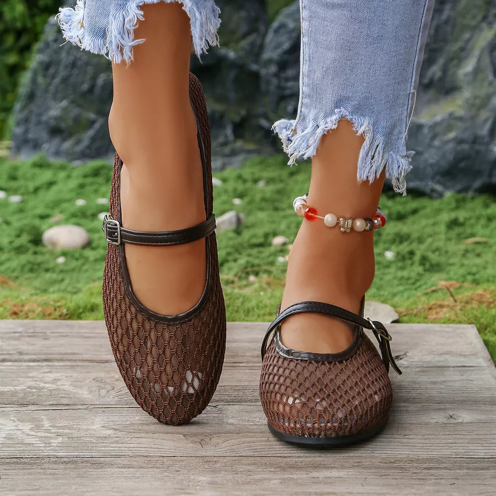 Brown mesh Mary Jane flats with adjustable ankle strap and buckle detail.