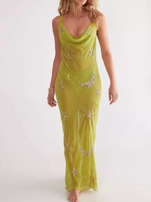 Green sheer cover-up dress with celestial sequin moon and star embellishments.