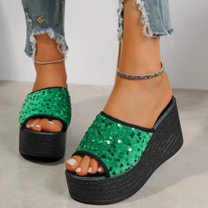 Green sequin platform wedge slides with black trim and sole.