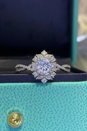 Silver halo twist ring with round and baguette diamonds in a floral design.