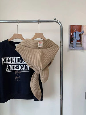 Ribbed knit winter scarf accessory in beige, tied at the front.