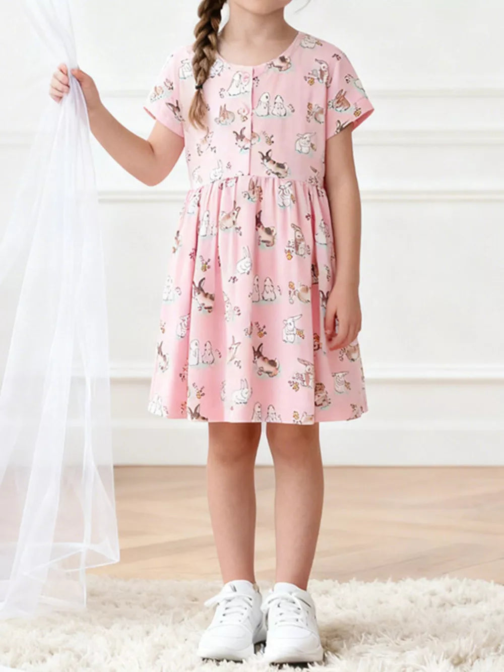 Pink cotton bunny print casual dress for toddlers with short sleeves and a round neckline.