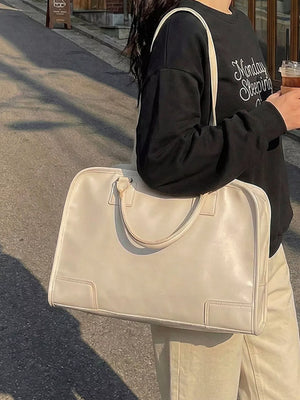 Cream pu leather travel bag with top handles and versatile strap.