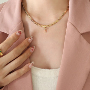 Gold textured chain necklace with a small diamond initial T charm