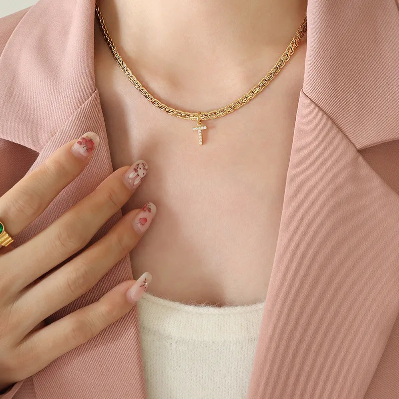 Gold textured chain necklace with a small diamond initial T charm