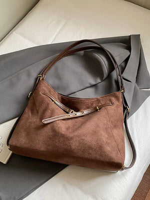 Brown suede large tote bag with adjustable strap detail and gold hardware.