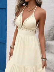 Cream halter neck maxi dress with tiered skirt and shell trim detail