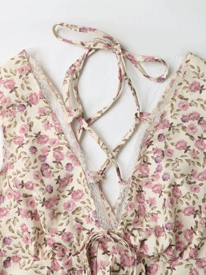Floral lace tie mini dress with crisscross back detail and delicate lace trim.