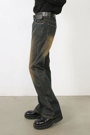 Faded wash bootcut jeans in olive brown with dip dye effect and distressed detailing.