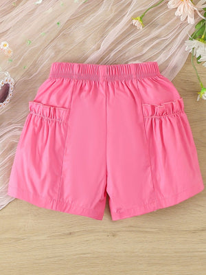 Baby shorts in bright pink with elastic waist and ruffled pockets.