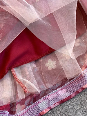 Crimson maxi dress with floral tulle overlay and sweetheart neckline detail.