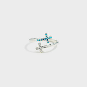 Sterling silver ring with intertwined crosses, one with blue zircon, one with clear zircon.