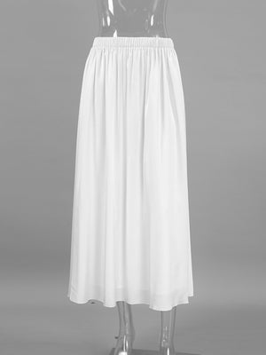 White high-waisted maxi skirt with pockets and flowy silhouette.