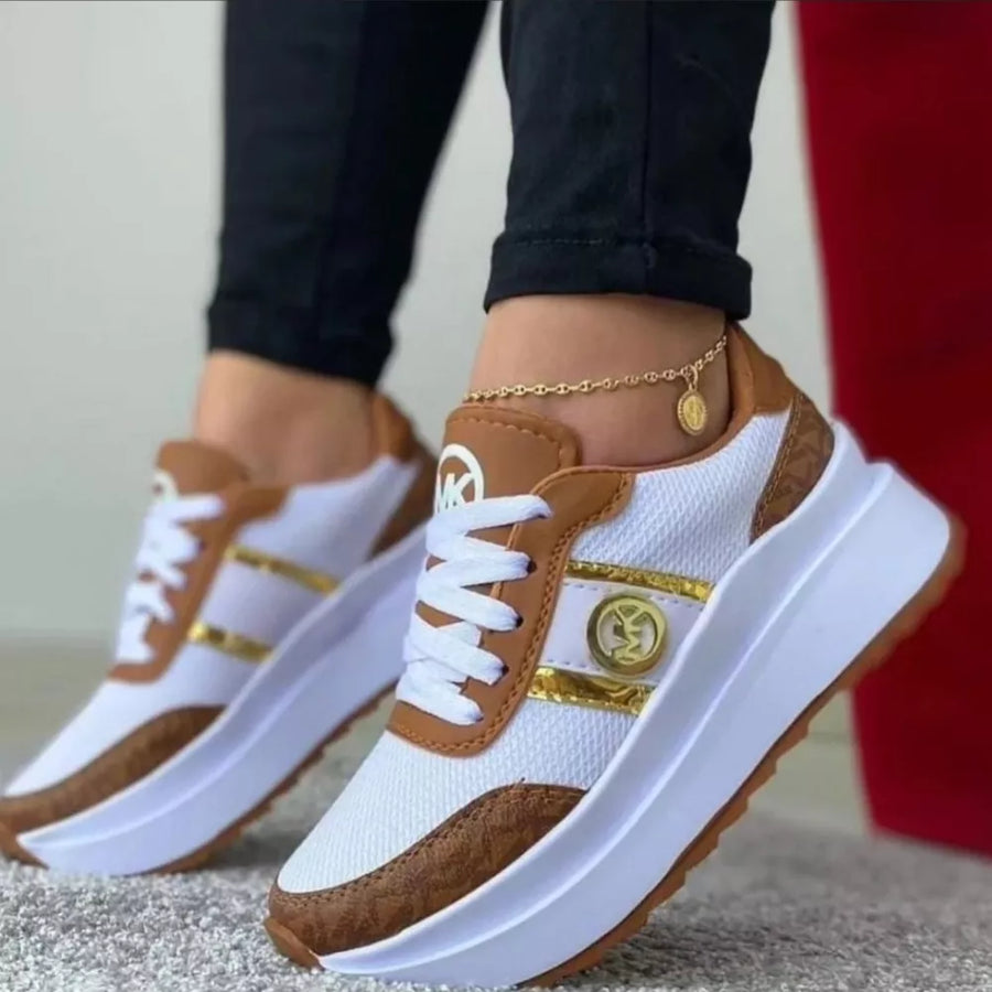 White and brown platform sneakers with gold accents and round toe.