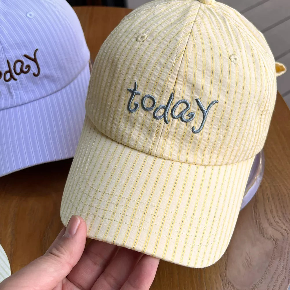 Yellow pastel striped cotton baseball cap with embroidered "today" text.