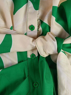 Belted shirt dress with abstract green and cream print, featuring button-down front and tie waist.