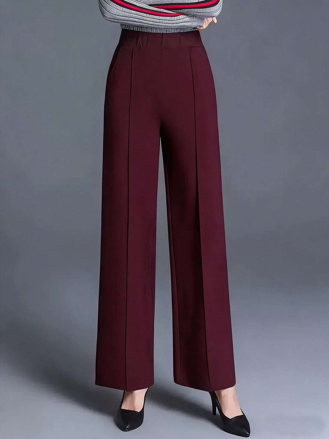 Burgundy high-waisted wide leg cotton trousers with front seams and pockets.