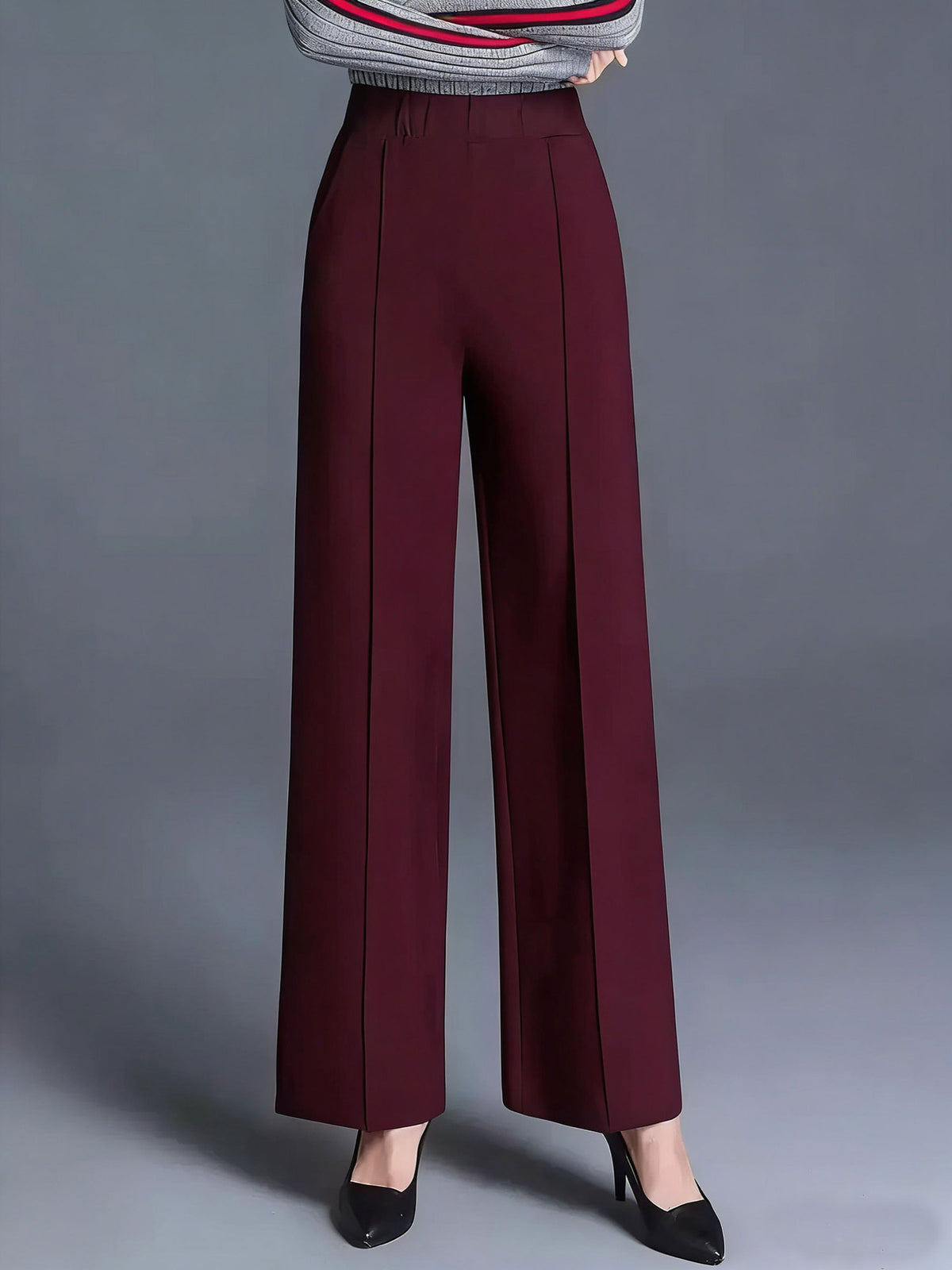 Burgundy high-waisted wide leg cotton trousers with front seams and pockets.