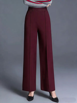 Burgundy high-waisted wide leg cotton trousers with front seams and pockets.