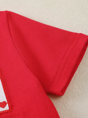 Red baby set with Xoxo heart print detail on a white patch and short sleeves.